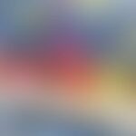 A colorful blurred image with a gradient of blue, red, and yellow hues.
