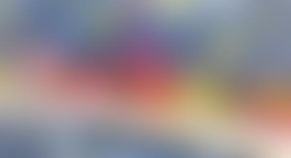 A colorful blurred image with a gradient of blue, red, and yellow hues.