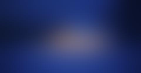 Blurred image with indistinct shapes on a blue background.