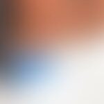 Abstract gradient with warm orange and cool blue tones.