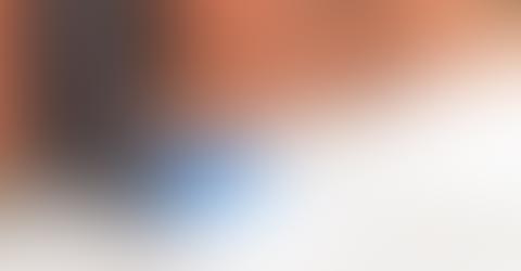 Abstract gradient with warm orange and cool blue tones.
