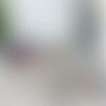 Blurry image of a light-filled room with indistinct furniture and decor.